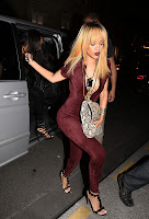 Rihanna wearing a red catsuit