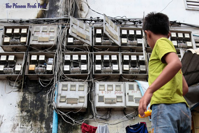 A young boy walks past power meters at the White Building in Phnom Penh earlier this year. Hong Menea