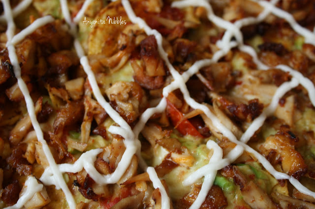 A tray of nachos made from leftover barbecue chicken with roasted tomatoes