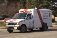 An ambulance with sirens on