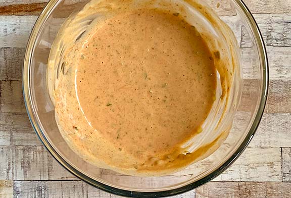 Thousand island dressing ingredients mixed together in a bowl.