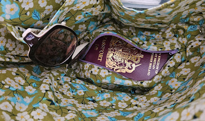 Interior shot of basket lining with passport just peeking out of hidden zippered pocket
