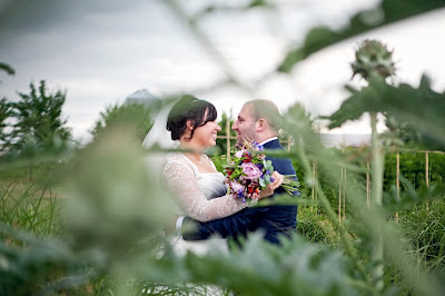 Newly married couple hugging amid greenary