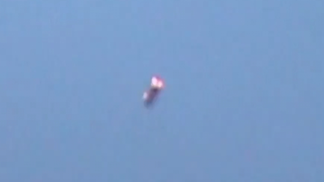 Brazil UFO sighting that looks like a Cigar shaped UFO filmed with a pinkish red light on the front of the UFO.