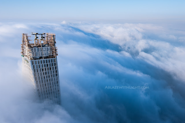 Photo of Infinity tower's top floors above the fog