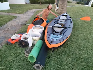 The inflated boat, our isolation mats and other luggage on a lawn