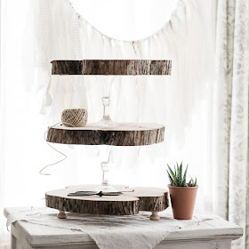 How to make a rustic three tier stand with reclaimed wood slices and glass candlesticks. | personallyandrea.com