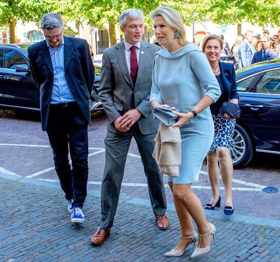 Queen Maxima wore a sky blue silk dress by Natan, blue floral earrings, Gianvito Rossi pumps