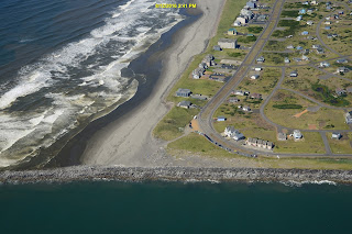 Aerial view of ocean beach and jetty sea wall