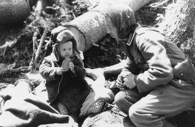 1942, Russia - German soldier offered bread to Russian boy survivor