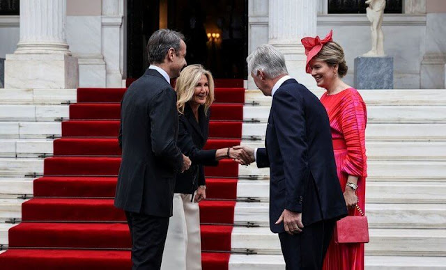 Queen Mathilde wore a red printed pleated twill dress by Natan. President Katerina Sakellaropoulou and Mareva Grabowski