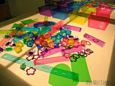 Colorful objects on the light table from And Next Comes L