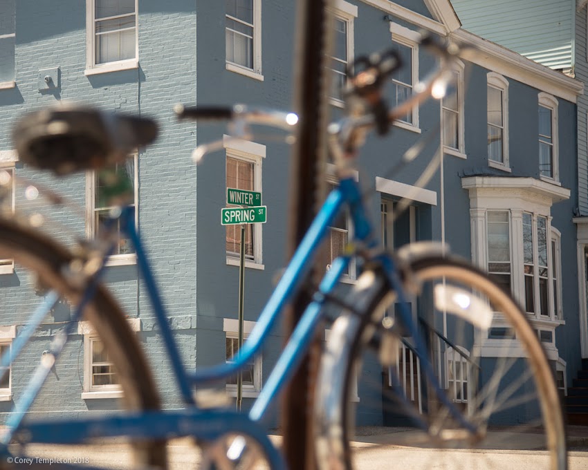 Portland, Maine USA April 2018 photo by Corey Templeton. Step Through bicycle to Winter and Spring Street signs in the West End.