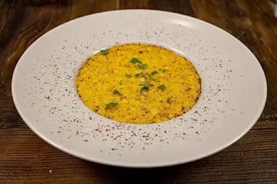 Risotto Milanese served creamy with saffron and grated cheese