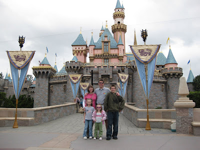 The family in front of the Magic Castle at the entrance of Fantasyland