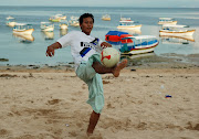 kicker. a game of soccer at dusk in benoa harbor, bali (soccer bali beach)