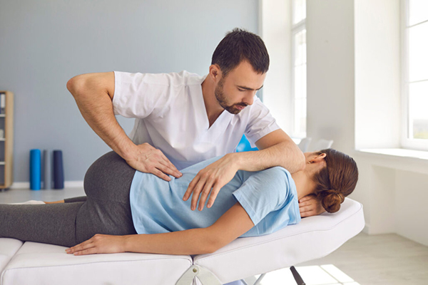 A person receiving chiropractic care. Illustrating the costs of chiropractic treatment without insurance and factors that influence pricing