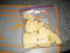 Apple, lemon juice and brown sugar in a plastic bag.