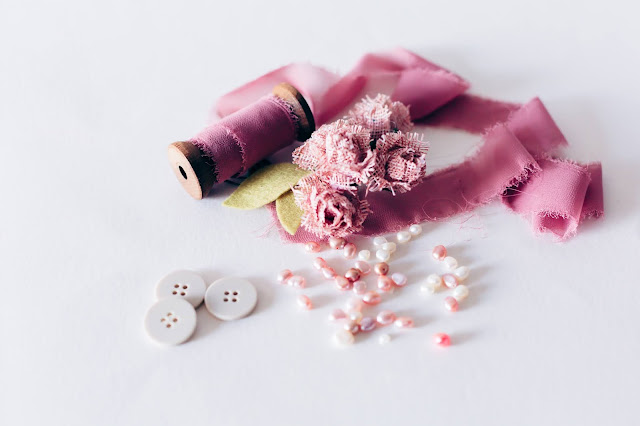 Pink ribbons and beads; white buttons