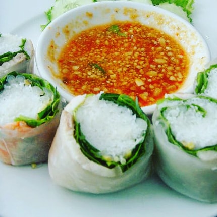 rice paper spring rolls and chilli sauce in the vietnamese city of ho chi minh, one of the best travel destinations for foodies