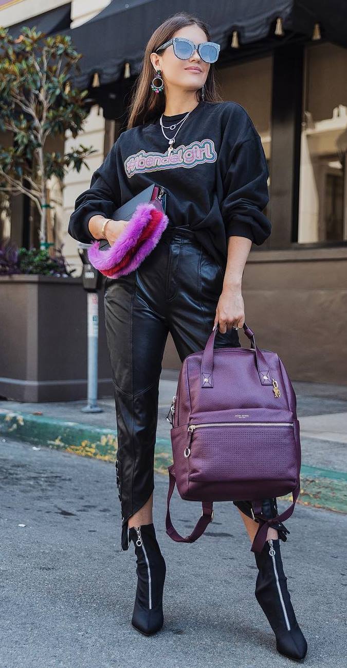 how to style a pair of leather pants : black sweatshirt + burgundy bag + boots