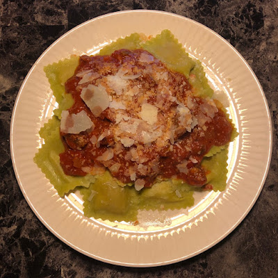 Sun dried tomato and goat cheese ravioli with red sauce and shaved parmesan