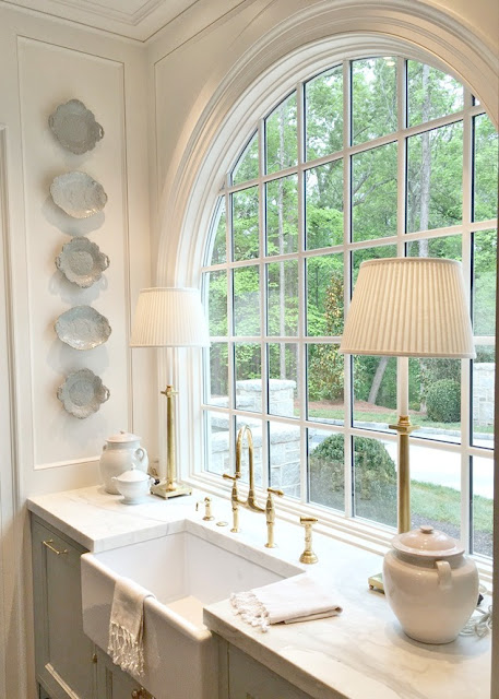 Farm sink with arch window in blue and white traditional kitchen in Southeastern Designer Showhouse & Gardens 2017