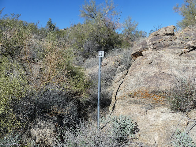 03: small white sign on a tall metal rod