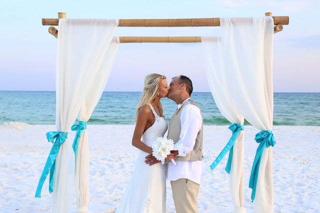 Decorated bamboo wedding arbor for your Destin Beach Wedding, turquoise and ivory fabric and sashes 