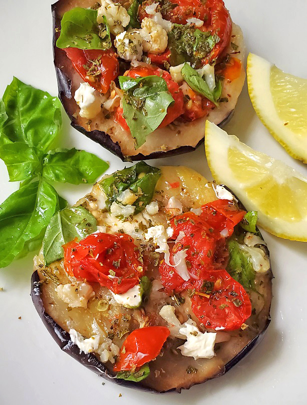 this is feta cheese, tomato on top of eggplant Greek style baked