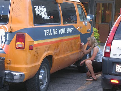 Participant writing her recession story on the van