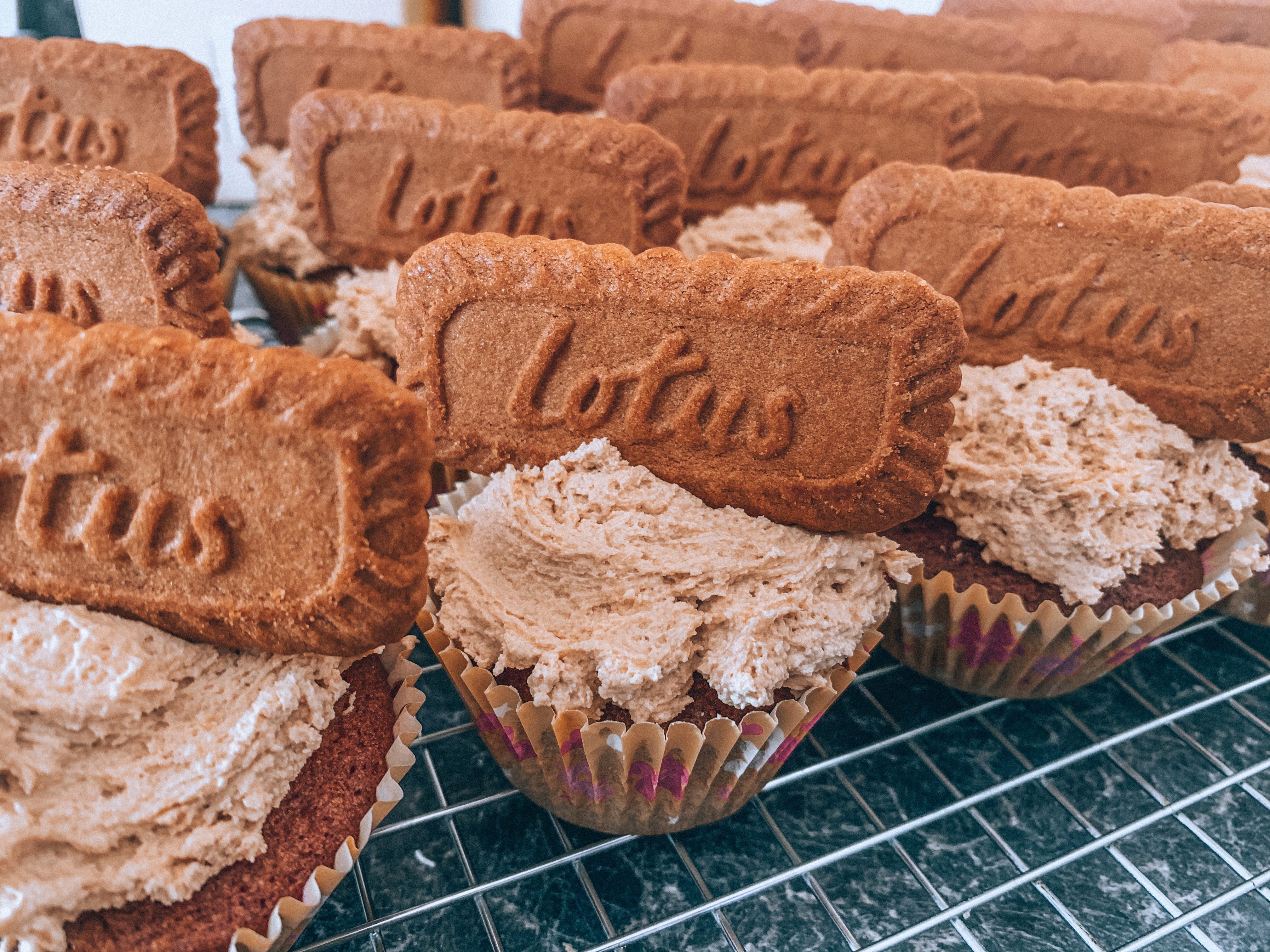 Close up of a group of cupcakes with icing and biscoff biscuit