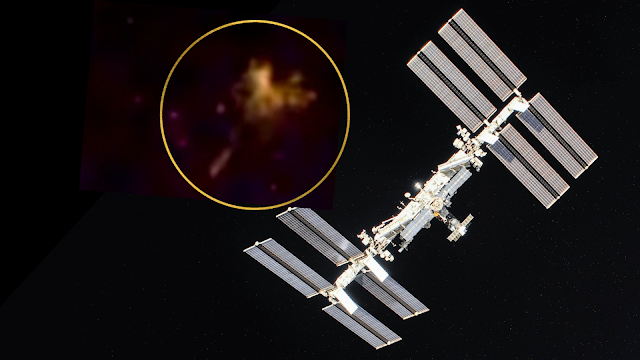 UFO uncloaks at the side of the ISS and it's huge.