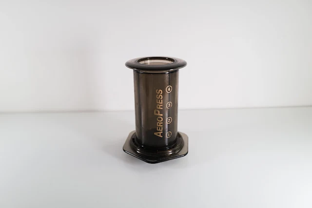An Aeropress on a white table
