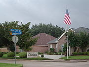 The entrance to a subdivision in Sugar Land, Texas. Subdivision is the act of dividing land into pieces that are easier to sell or otherwise develop, usually via a plat. The former single piece as a whole is then known as a subdivision; if it is used for housing it is typically known as a housing subdivision or housing development, although some developers tend to call these areas communities.  Subdivisions may also be for the purpose of commercial or industrial development, and the results vary from retail malls with independently owned out parcels to industrial parks. 