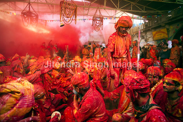 Here comes the very first and rocking PHOTO JOURNEY by Jitendra Singh, one of the great photographers. Photographers at PHOTO JOURNEY welcome Mr. Jitendra Singh and congratulate him for his first PHOTO JOURNEY with great colors. Let's check out these interesting Holi photographs from Barsana, Nandgaon, Goverdhan, Vrindavan and Mathura...The Hindu festival of Holi which is also called as the Festival of Colors celebrated with much enthusiasm in the month of Phalgun, which usually corresponds to the month of March. It marks the arrival of spring and the bright colors represent energy, life, and joy. The festival of colors is also very special for Photographers like Jitendra Singh, who visited one of the important places in India where Holi is celebrated in very special ways. This Photo Journey shares photographs from various parts of Uttar Pradesh.In Mathura, the birthplace of Lord Krishna and in Vrindavan this day is celebrated with special puja and the traditional custom of worshiping Lord Krishna, here the festival lasts for sixteen days. All over the Braj region and its nearby places like Hathras, Aligarh, Agra the Holi is celebrated in more or less same way as in Mathura, Vrindavan and Barsana. This great festival is associated with the immortal love of Lord Krishna and Radha and hence, Holi is spread over 16 days in Nandgaon, Barsana, Goverdhan, Vrindavan as well as Mathura - the cities with which Lord Krishna shared a deep affiliation. Apart from the usual fun with colored powder and water, Holi is marked by vibrant processions which are accompanied by folk songs, dances and a general sense of abandoned vitality. These photographs share the mood of Holi with great enthusiasm, music, dance and lot of excitement in various forms. Barsana is the place to be at the time of Holi. Here the famous Lath mar Holi is played in the sprawling compound of the Radha Rani temple. Thousands gather to witness the Lath Mar holi when women beat up men with sticks as those on the sidelines become hysterical, sing Holi Songs and shout Sri Radhey or Sri Krishna. The Holi songs of Braj mandal are sung in pure Braj BhashaHoli is known by the name of 'Dol Jatra', 'Dol Purnima' or the 'Swing Festival'. The festival is celebrated in a dignified manner by placing the icons of Krishna and Radha on a picturesquely decorated palanquin which is then taken round the main streets of the city or the village. The devotees take turns to swing them while women dance around the swing and sing devotional songs. During these activities, the men keep spraying colored water and colored powder, abir, at them.The Holi celebration has its celebration origins in Gujarat, particularly with dance, food, music, and colored powder to offer a spring parallel of Navratri, Gujarat's Hindu festival celebrated in the fall. Falling on the full moon day in the month of Phalguna, Holi is a major Hindu festival and marks the agricultural season of the Rabi cropOn Dol Purnima day in the early morning, the students dress up in saffron-colored or pure white clothes and wear garlands of fragrant flowers. They sing and dance to the accompaniment of musical instruments like ektara, dubri, veena, etc. Holi played at Barsana is unique in the sense that here women chase men away with sticks. Males also sing provocative songs in a bid to invite the attention of women. Women then go on the offensive and use long staves called lathis to beat men folk who protect themselves with shieldsIn Maharashtra, Holi is mainly associated with the burning of Holika. Holi Paurnima is also celebrated as Shimga. A week before the festival, youngsters go around the community, collecting firewood and money. On the day of Holi, the firewood is arranged in a huge pile at a clearing in the locality. 