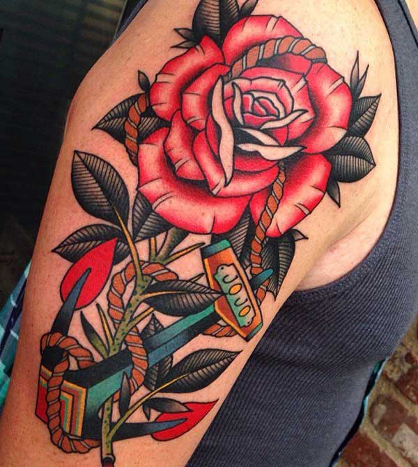 This rose tattoo looks good with black leaves and anchor rope wrapped