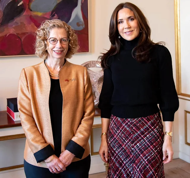 Queen Mary wore a black high collar sweater by Co and a boucle tweed midi skirt by Alexander McQueen