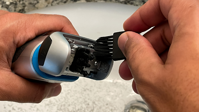 Cleaning the electric shaver with brush