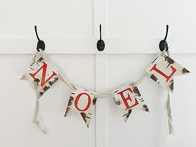 NOEL banner hanging on hooks