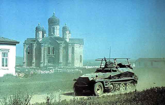A German Sdkfz 250 passes by Russian Eastern Orthodox Church. 7 October 1941 worldwartwo.filminspector.com