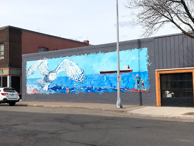 Beautiful mural of a snowy owl and Lake Superior by Adam Swanson in Duluth's Our Lincoln Park.