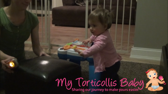 Baby with mild torticollis reaching for toy during a cruising exercise.