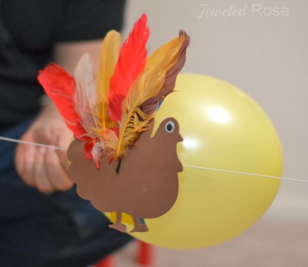 Wow the kids this fall and make turkey balloon rockets!  This fun science experiment is great for preschool! #balloonrockets #balloonrocketsforkids #balloonrocketsexperiments #turkeyballoons #turkeyballoonrockets #turkeyrocketrace #fallscience #turkeyrocket #scienceexperimentskids #growingajeweledrose #activitiesforkids