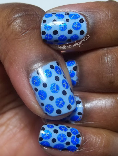 Manicure using a dotting tool to create dots in 2 sizes and 2 colours. The larger dots were made using blue crackle polish to give an interesting effect, and the smaller dots were made with black polish.