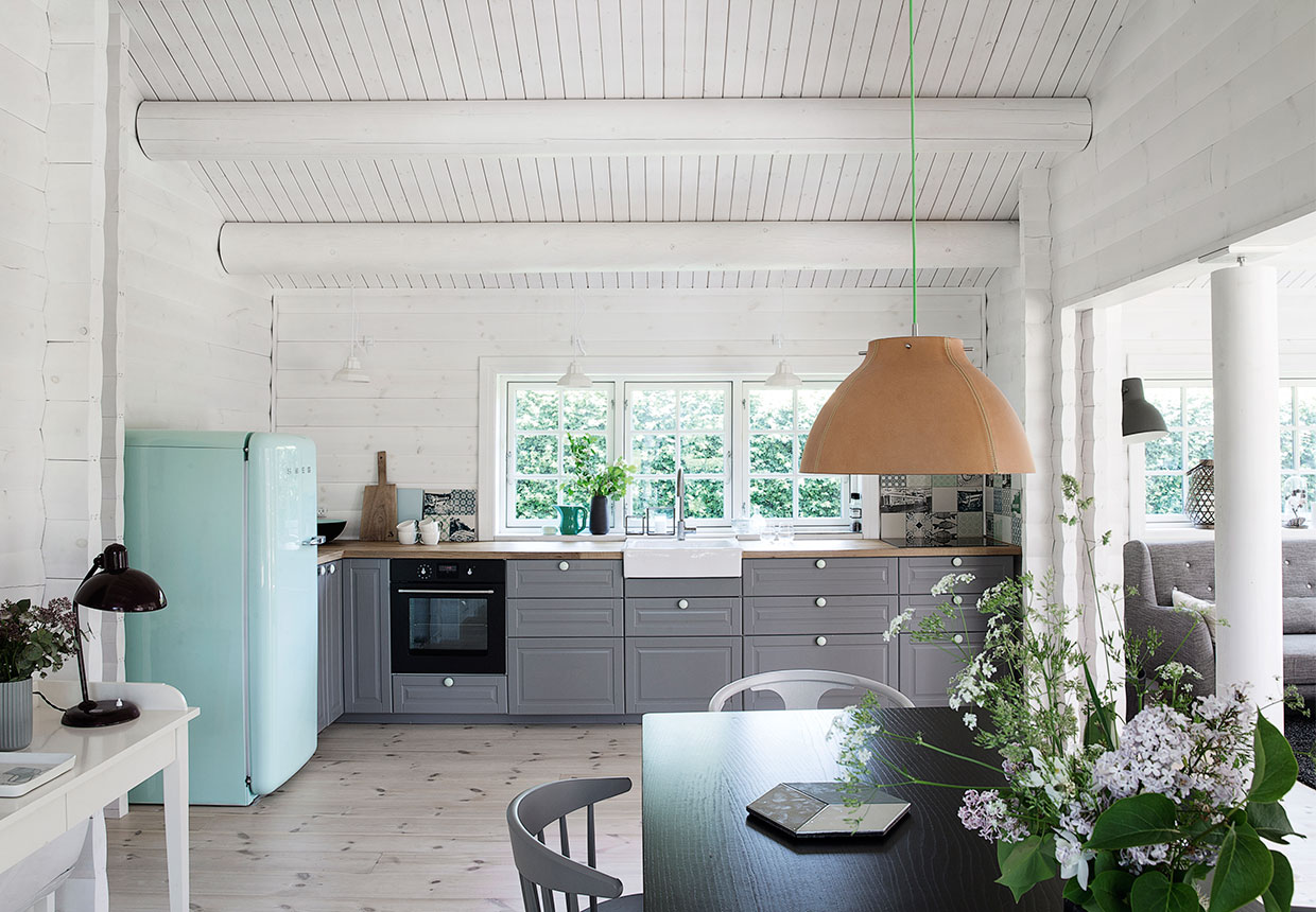inside of a log cabin, scandinavian interior design, black and white, gray kitchen, robin egg blue fridge