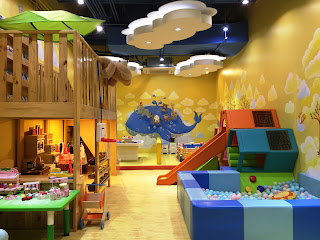 Bright and playful interior of Happynest Play & Learn Cafe with slide, tent, and playhouse