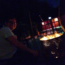 Jesse cooking over his fire pit