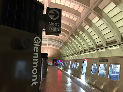 Photo of the platform of the Glenmont Metro Station with a train waiting.