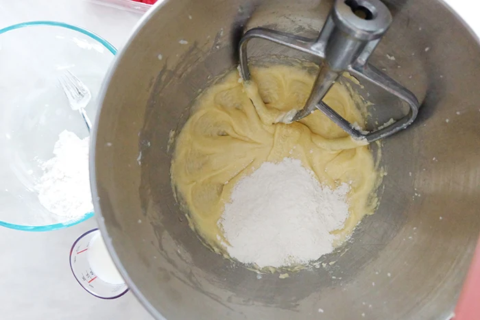 adding dry and wet ingredients to mixer bowl